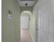 Hallway with light green walls and arched doorways at 3370 Dover Dr, Punta Gorda, FL 33983