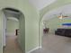 Hallway with arched doorways leading to living and dining areas at 3370 Dover Dr, Punta Gorda, FL 33983