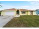 Front view of a yellow house with a stone facade at 3370 Dover Dr, Punta Gorda, FL 33983