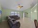Spacious living room featuring a large sectional sofa and tile flooring at 3370 Dover Dr, Punta Gorda, FL 33983