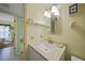 Bright bathroom with a white vanity, square mirror, and open doorway to the bedroom at 367 Coldeway Dr # H10, Punta Gorda, FL 33950