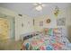 Bedroom features floral bedding, ceiling fan, and a view of the bathroom at 367 Coldeway Dr # H10, Punta Gorda, FL 33950