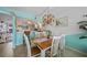 Inviting dining area with bright light fixtures and a view into the home's kitchen at 367 Coldeway Dr # H10, Punta Gorda, FL 33950