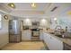 Bright kitchen with stainless steel appliances, white cabinetry, and wood-look flooring at 367 Coldeway Dr # H10, Punta Gorda, FL 33950