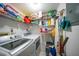 Laundry room with a washer, dryer, shelves, and cleaning supplies for convenience at 367 Coldeway Dr # H10, Punta Gorda, FL 33950
