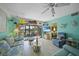 Bright living room features fun coastal decor, a ceiling fan and patio doors at 367 Coldeway Dr # H10, Punta Gorda, FL 33950