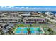 Overhead view of community pickleball courts surrounded by palm trees and lush landscaping at 367 Coldeway Dr # H10, Punta Gorda, FL 33950