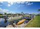 Scenic waterfront featuring multiple boats docked along a well-maintained grassy shoreline at 367 Coldeway Dr # H10, Punta Gorda, FL 33950
