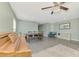 Open living area with wood flooring, a dining table, and a comfortable teal chair at 3867 Winer Rd, North Port, FL 34288