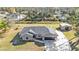 Aerial view of single story house with gray exterior, attached garage, and long concrete driveway at 4175 Horseshoe Ave, North Port, FL 34286