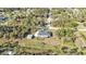 An aerial shot shows a house with a shed, trees, and natural surroundings at 4175 Horseshoe Ave, North Port, FL 34286