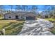 Charming single story house with gray exterior, attached garage, and long concrete driveway at 4175 Horseshoe Ave, North Port, FL 34286