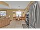 Eat-in kitchen featuring a built-in breakfast nook, stainless steel fridge, and tiled flooring at 4175 Horseshoe Ave, North Port, FL 34286