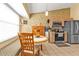 Eat-in kitchen featuring a breakfast nook, stainless steel fridge, and modern appliances at 4175 Horseshoe Ave, North Port, FL 34286