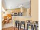 Eat-in kitchen features stainless steel appliances, a breakfast bar with seating, and adjacent dining space at 4175 Horseshoe Ave, North Port, FL 34286