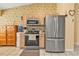Efficient kitchen featuring stainless steel appliances, wood cabinets, and tiled floors at 4175 Horseshoe Ave, North Port, FL 34286