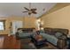 Comfortable living room with vaulted ceiling, ceiling fan, and ample seating for relaxing or entertaining guests at 4175 Horseshoe Ave, North Port, FL 34286