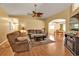 Inviting living room featuring wood floors, a ceiling fan, and comfortable seating for relaxing and entertaining at 4175 Horseshoe Ave, North Port, FL 34286