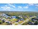 Aerial view showcasing homes, street, canal and lush greenery with a scenic waterfront at 4254 Bur St, Port Charlotte, FL 33948