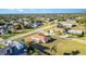 An aerial view captures the home nestled in a neighborhood with lush green lawns and mature landscaping at 4254 Bur St, Port Charlotte, FL 33948