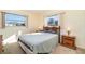 Cozy bedroom featuring two windows providing natural light, wooden furniture, and a comfortable bed at 4254 Bur St, Port Charlotte, FL 33948