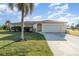 Charming single-story home with arched entryway, two-car garage and meticulous landscaping at 4254 Bur St, Port Charlotte, FL 33948