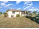 Exterior view of the home, showcasing the screened in patio and spacious backyard at 4254 Bur St, Port Charlotte, FL 33948