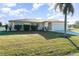Well-maintained single-story home featuring a 2-car garage, manicured lawn and beautiful tropical landscaping at 4254 Bur St, Port Charlotte, FL 33948