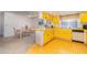 Open concept kitchen and dining area with yellow countertops and cabinets plus tile floors at 4254 Bur St, Port Charlotte, FL 33948