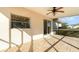 Relaxing covered patio with tiled flooring, a ceiling fan, and access to the backyard at 4254 Bur St, Port Charlotte, FL 33948