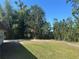Backyard featuring a spacious lawn with natural landscaping and vegetation at 432 Olivia Rd, Venice, FL 34293