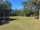 Expansive backyard with well-maintained lawn and screened porch at 432 Olivia Rd, Venice, FL 34293