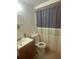 Practical bathroom featuring a toilet, sink and shower with sliding shower curtain at 432 Olivia Rd, Venice, FL 34293