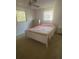 Bright bedroom with two windows, ceiling fan, and standard furnishings at 432 Olivia Rd, Venice, FL 34293