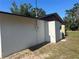 Exterior view featuring the home's utility access point and surrounding landscape at 432 Olivia Rd, Venice, FL 34293