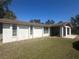 Exterior view of home featuring neutral colors and a well-maintained lawn at 432 Olivia Rd, Venice, FL 34293