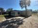 Home exterior featuring a screened porch and ample yard space at 432 Olivia Rd, Venice, FL 34293