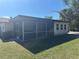 Back of house featuring a screened porch with ample room for relaxing at 432 Olivia Rd, Venice, FL 34293