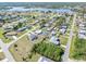 Neighborhood shot, with houses, green lawns, and access to a nearby lake at 530 Lakemont Nw Ave, Port Charlotte, FL 33952
