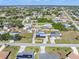 Wide aerial view showcasing multiple properties and the surrounding neighborhood at 530 Lakemont Nw Ave, Port Charlotte, FL 33952