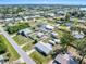 High aerial view of a residential neighborhood near a wide body of water and green spaces at 530 Lakemont Nw Ave, Port Charlotte, FL 33952