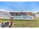 The backyard has a white vinyl fence, and a large inground pool at 530 Lakemont Nw Ave, Port Charlotte, FL 33952