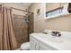Tiled bathroom featuring a walk-in shower and single sink vanity at 530 Lakemont Nw Ave, Port Charlotte, FL 33952
