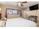 Relaxing bedroom with a ceiling fan and large window at 530 Lakemont Nw Ave, Port Charlotte, FL 33952