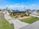 Aerial view of a charming home with lush landscaping,solar panels and extended driveway at 530 Lakemont Nw Ave, Port Charlotte, FL 33952