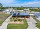 Aerial view of a charming home with lush landscaping, solar panels and long drive at 530 Lakemont Nw Ave, Port Charlotte, FL 33952