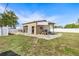 Exterior of a one-car metal garage with lawn equipment and gravel landscaping at 530 Lakemont Nw Ave, Port Charlotte, FL 33952