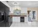 Bright kitchen with white cabinets, black appliances, and a view to an outdoor patio at 530 Lakemont Nw Ave, Port Charlotte, FL 33952