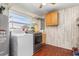 Spacious laundry room includes washer, dryer, and shelving for easy storage at 530 Lakemont Nw Ave, Port Charlotte, FL 33952
