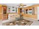 Comfortable living room with tile floors, ceiling fan, sofa, built-in shelving, and natural light from the window at 530 Lakemont Nw Ave, Port Charlotte, FL 33952